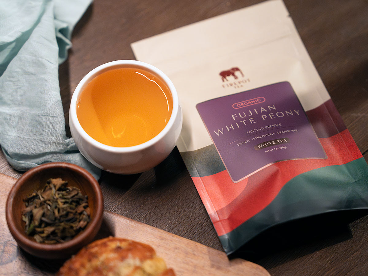 fujian white peony 1oz bag with cup of tea