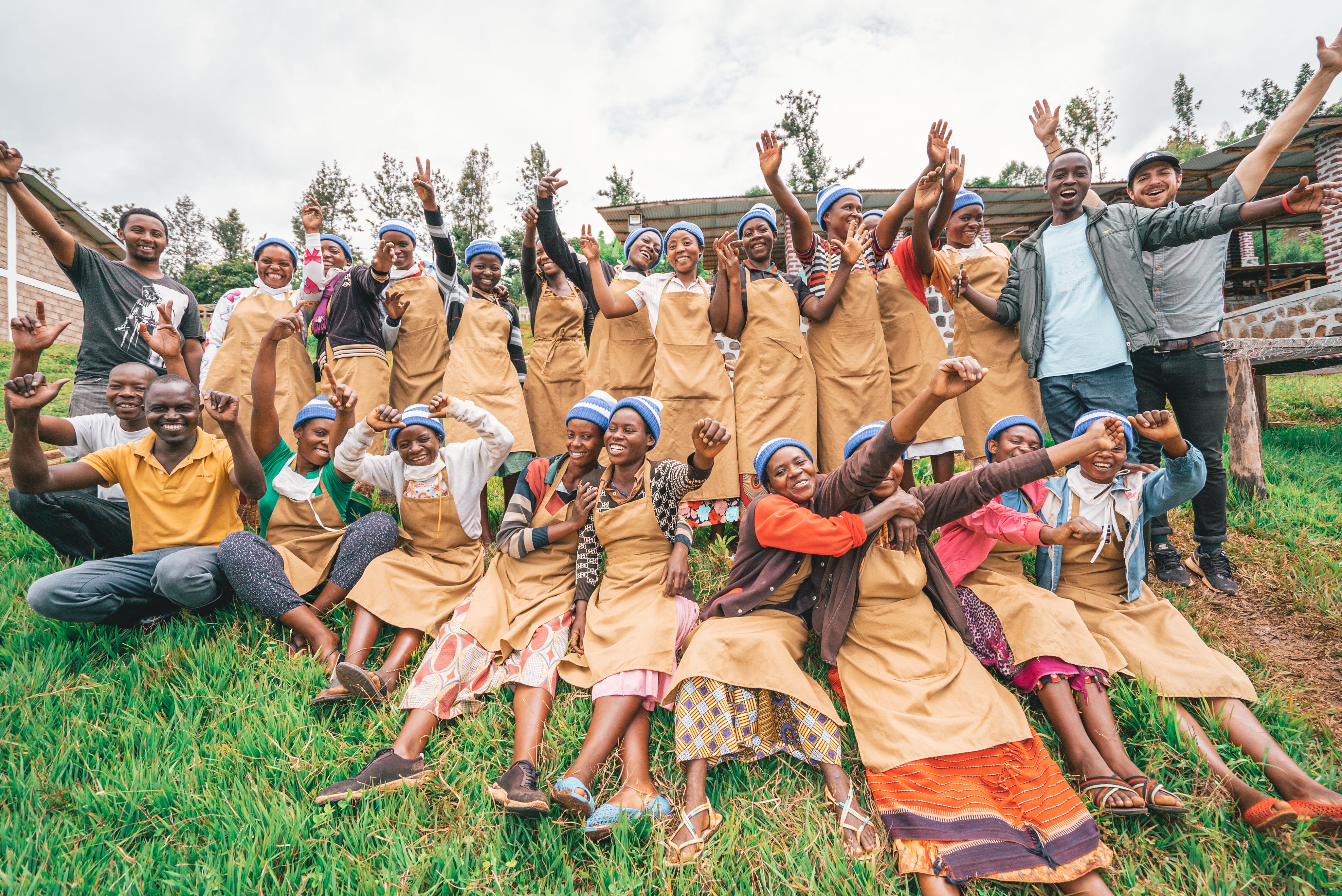 image of group of people smiling with their hands in the air from the Kula Project