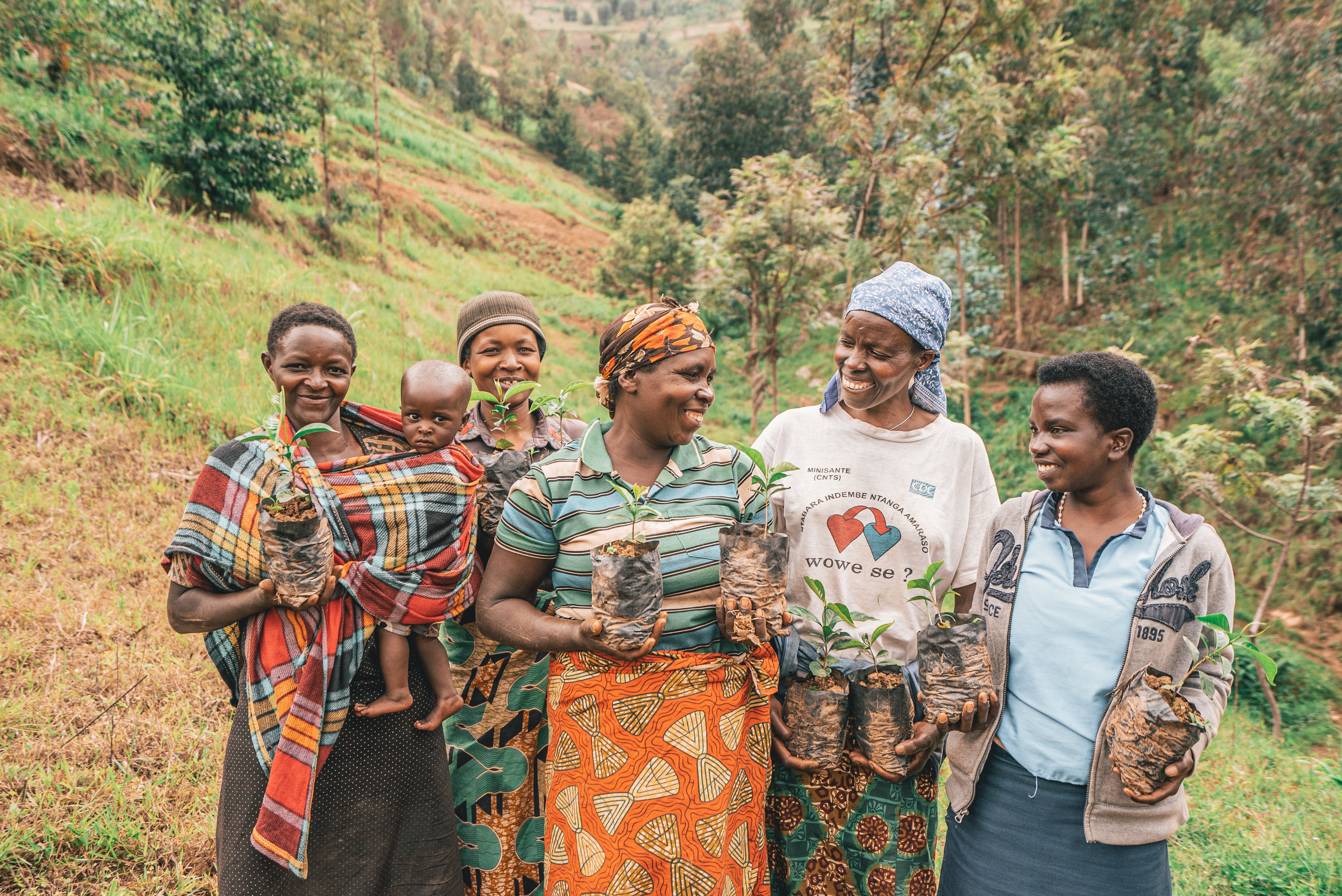 group of women farmers smiling with plants