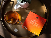 soul revival sachet box and glass of tea on a tray