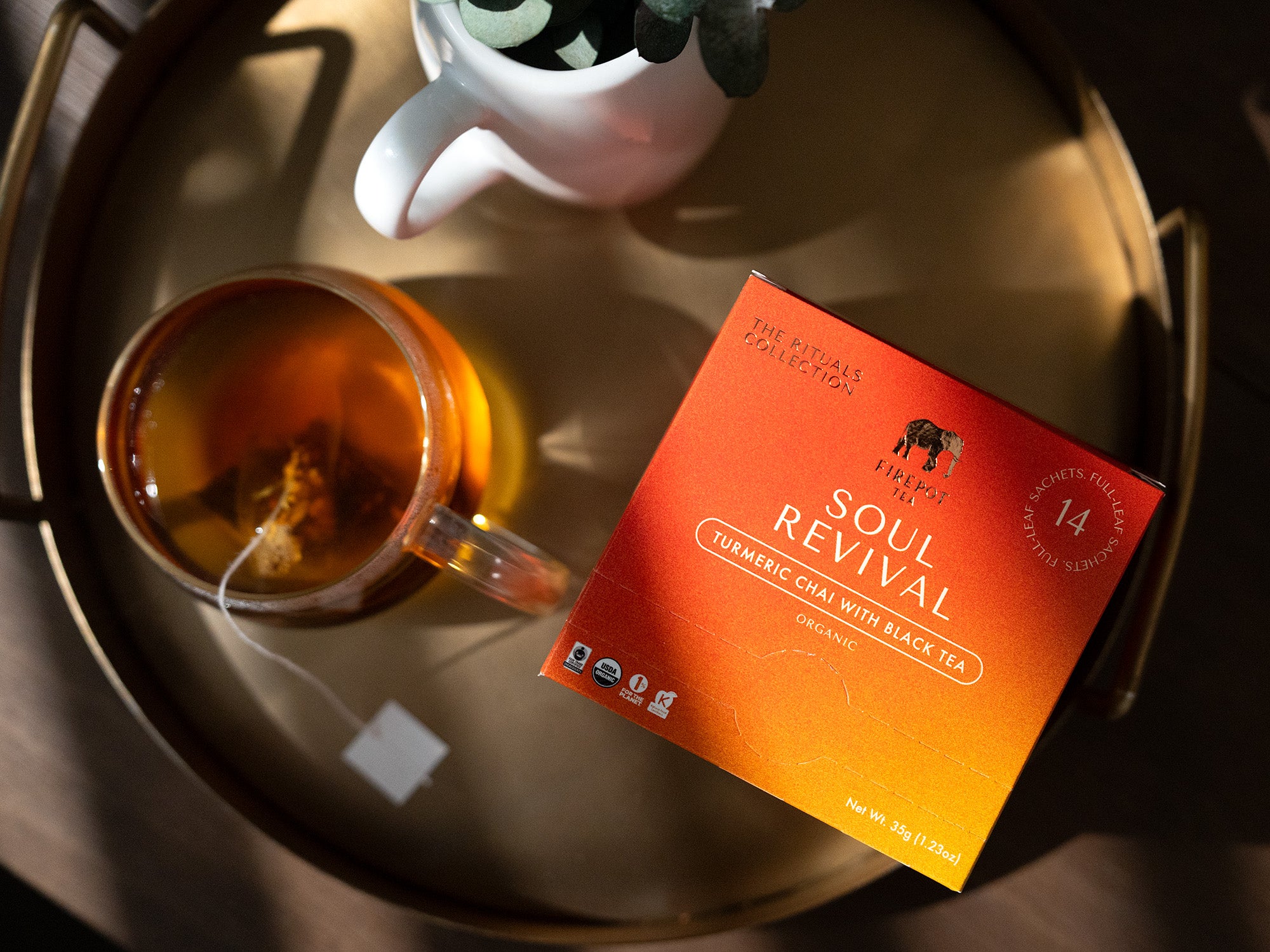 soul revival sachet box and glass of tea on a tray