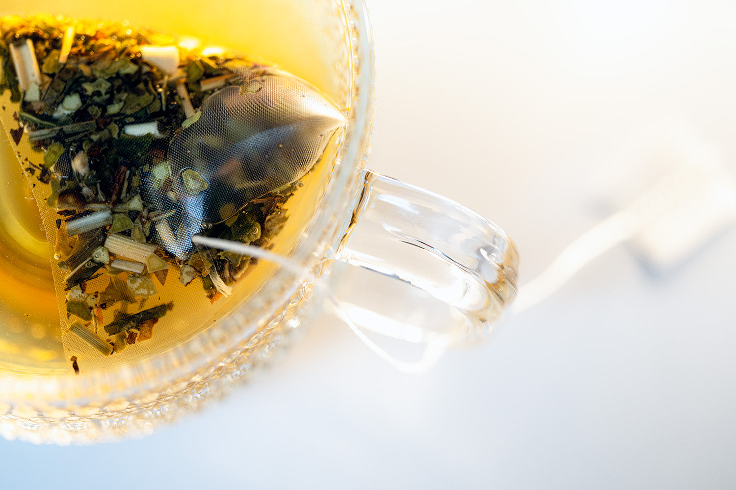 tea bag steeping in a glass mug