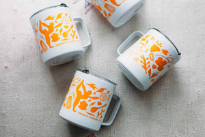 four Firepot Miir Mugs laying flat on a Moroccan blanket
