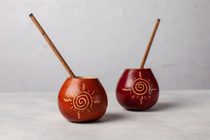 two handmade mate gourds with bamboo straws