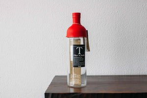 red Hario Filter-in Bottle Cold Brewed Tea bottle on a wooden shelf