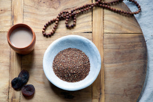 Firepot loose leaf Rooibos Chai in a bowl next to a chai latte in a cup
